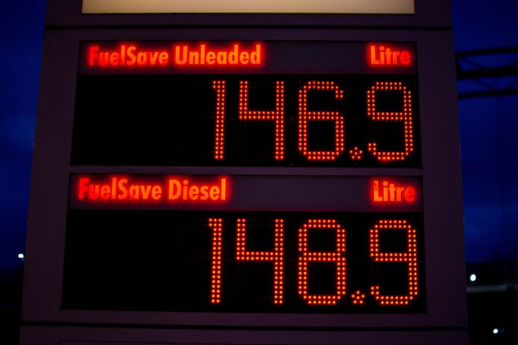 An LED sign displaying fuel pricing.